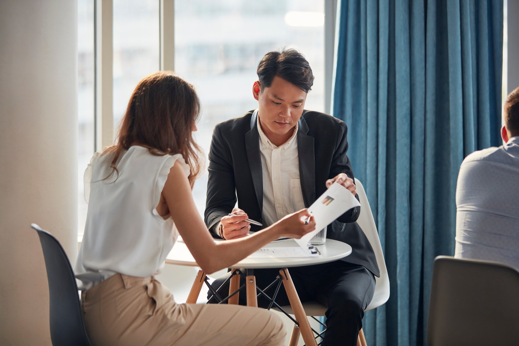 Diverse group of businesspeople discussing in pairs. Insurance sales agent.